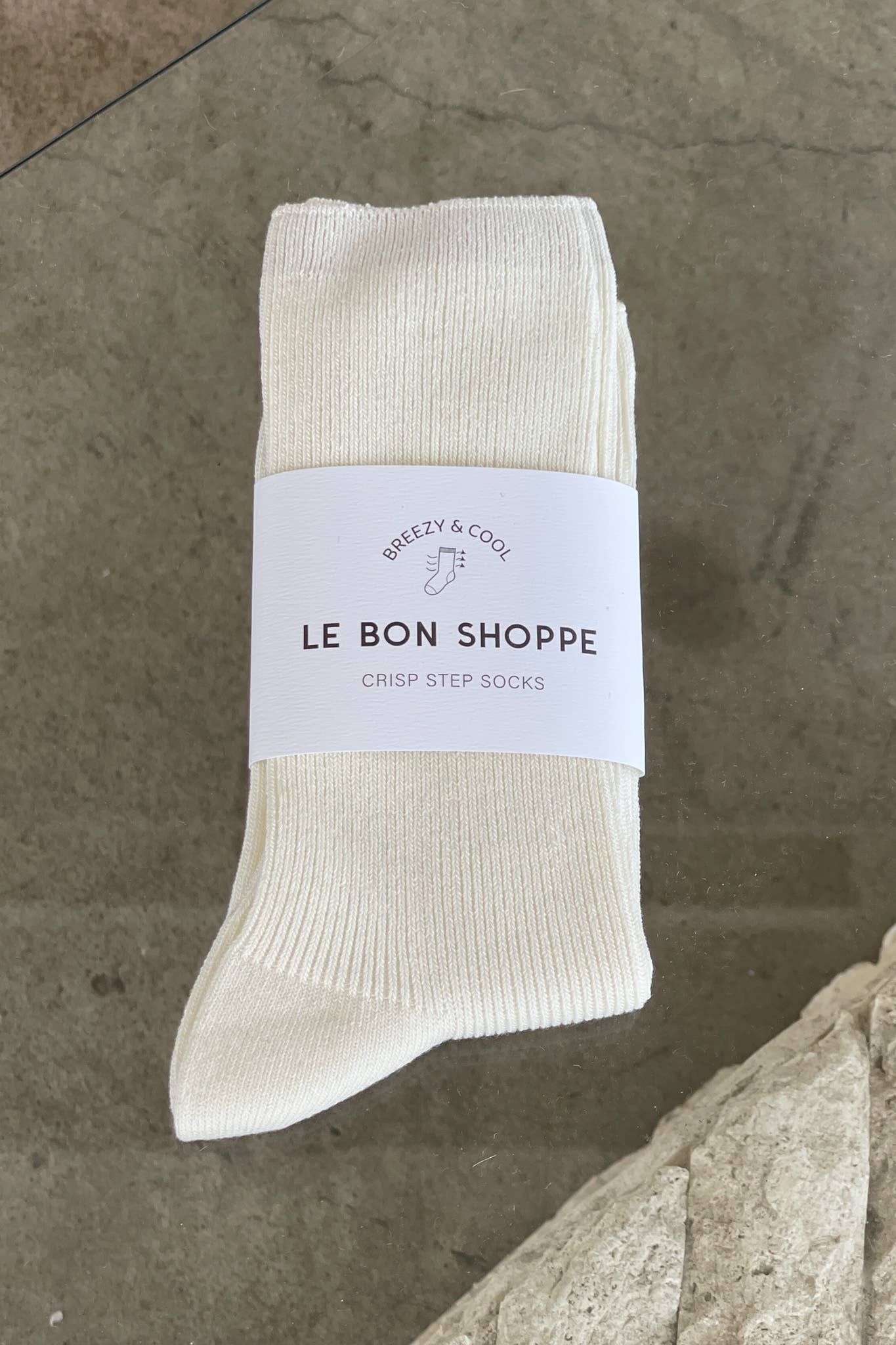 Beige sock with a label on a stone surface
