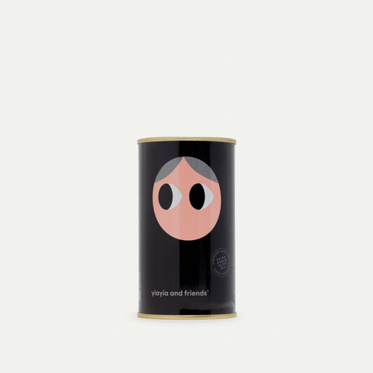 Black cylindrical container with a face design on a white background
