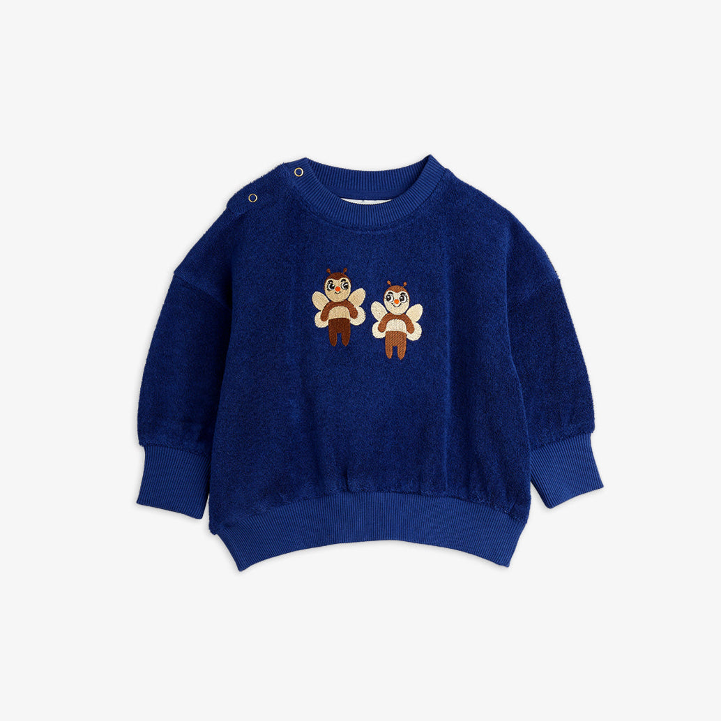 Blue sweater with cartoon character design on a white background