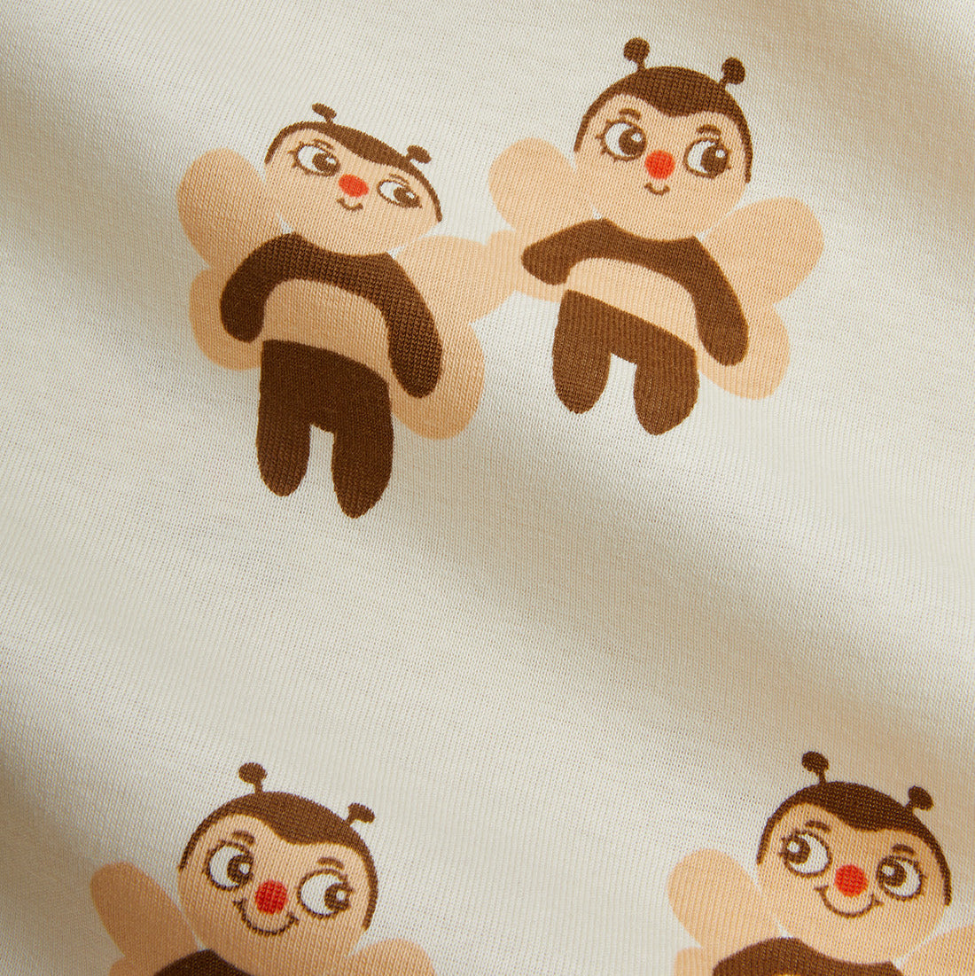 Pattern of cartoon bee characters on a beige background