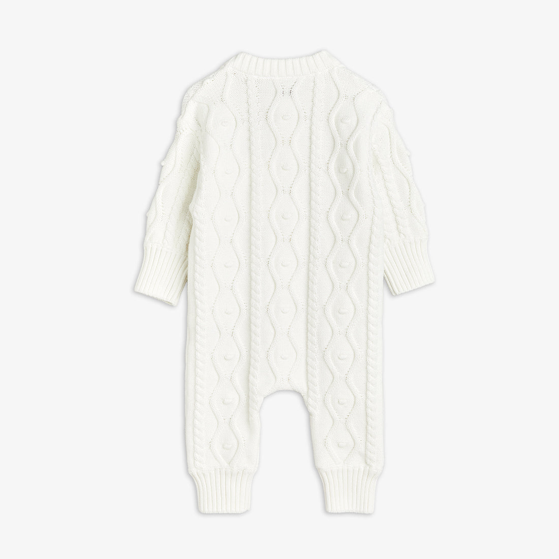 White cable knit baby romper on a light gray background