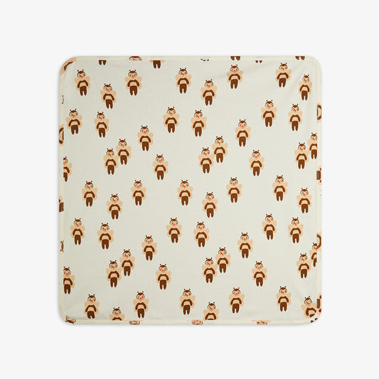 Patterned fabric with bee design on a beige background