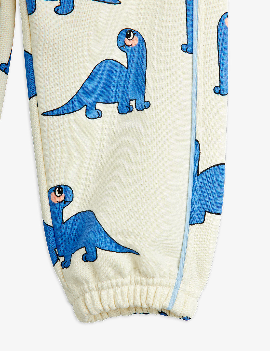 Children's pants with blue dinosaur pattern on a white background