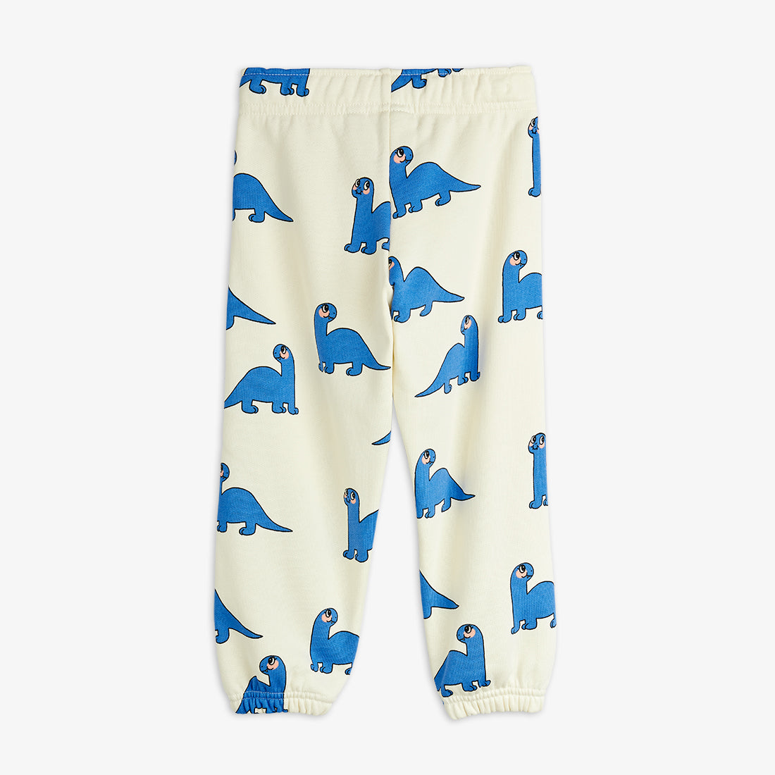 Cream-colored pants with blue dinosaur pattern on a white background