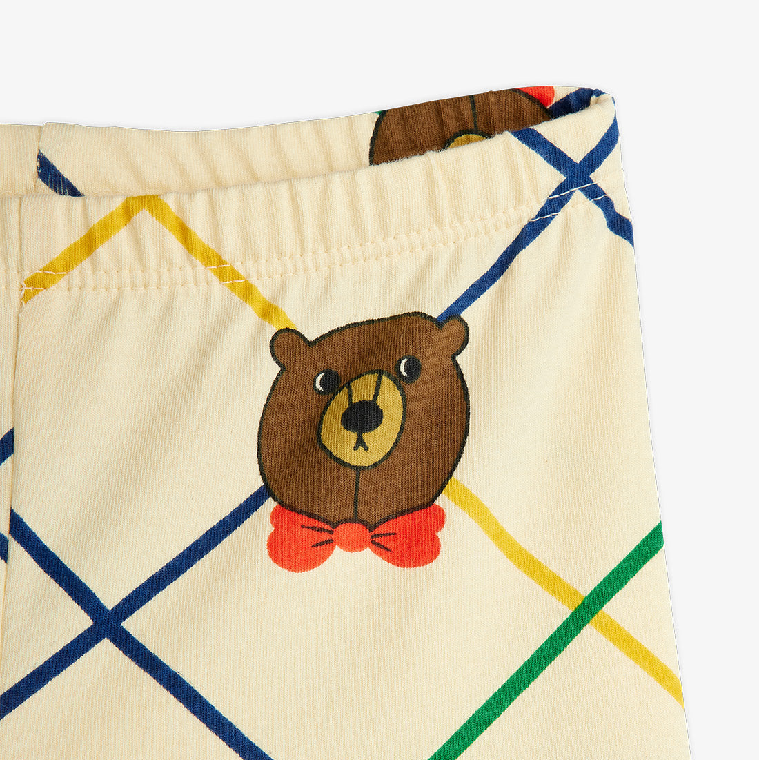 Beige shorts with a bear face and red bow tie on a white background