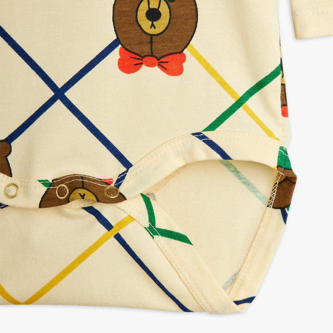 Fabric with teddy bear design and colorful lines on a white background