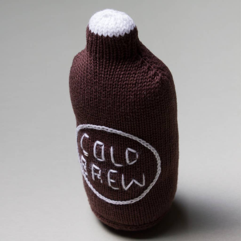 Knitted bottle rattle with 'Cold Brew' text on a gray background