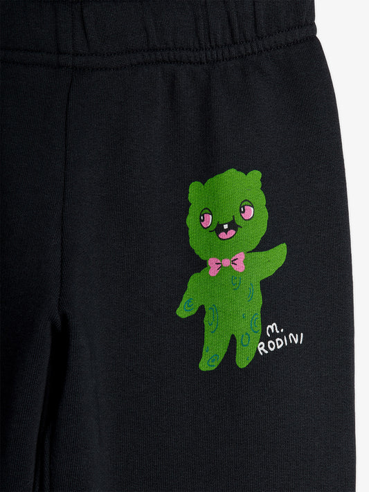Black pants with a green embroidered bear design and 'M. Rodini' branding.