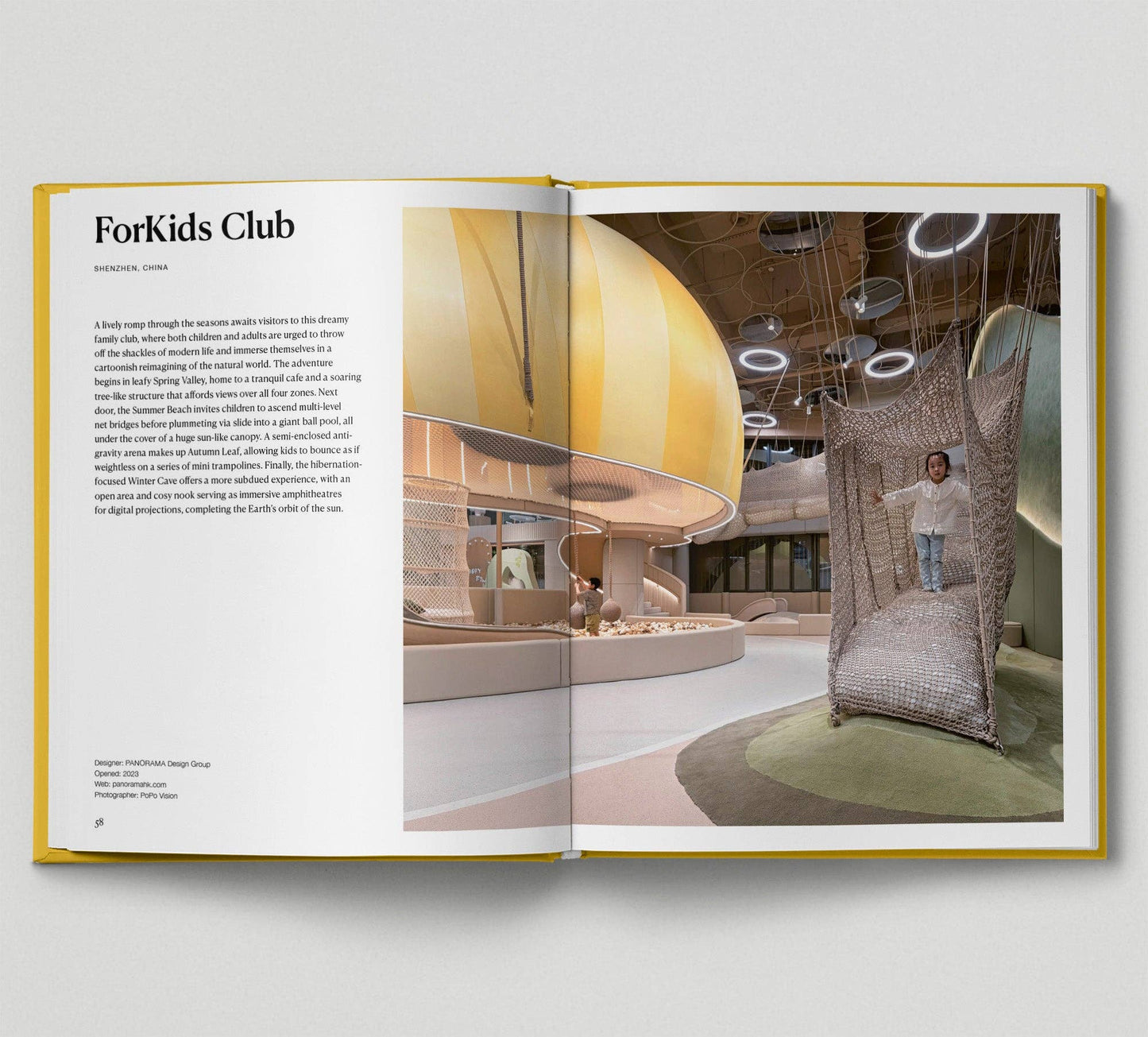 Open book showing a design project for a kids' club with interior elements.