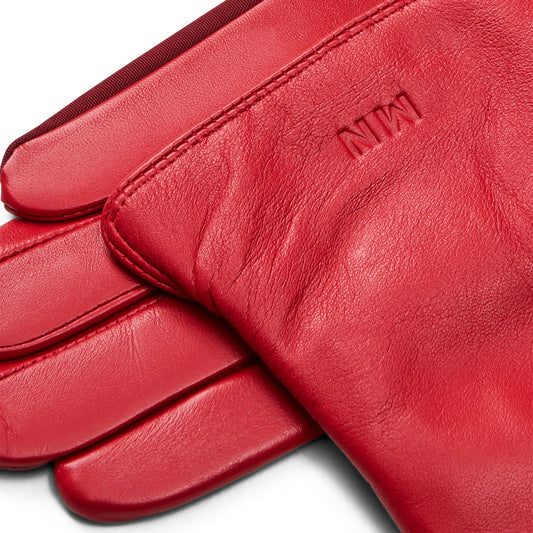 Red leather gloves with a brand logo on a white background