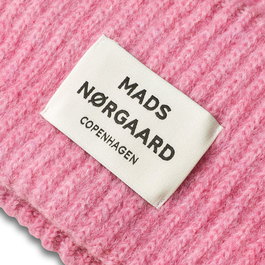 Mads Nærgaard label on a pink fabric background