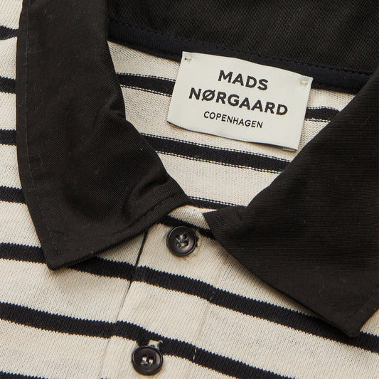 Close-up of a striped shirt collar with a Mads Nørgaard label.