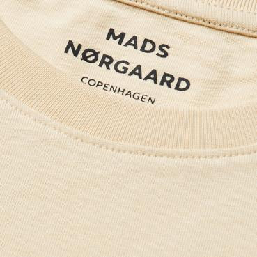Beige fabric with 'Mads Nørgaard Copenhagen' branding.