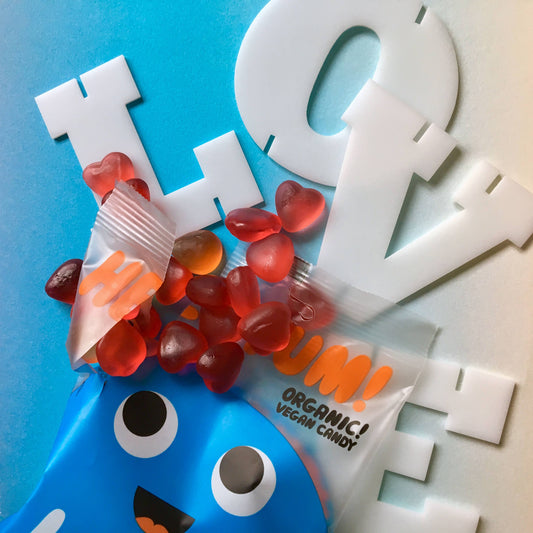 Candy package with red gummy bears and a blue character on a blue background with white letters.