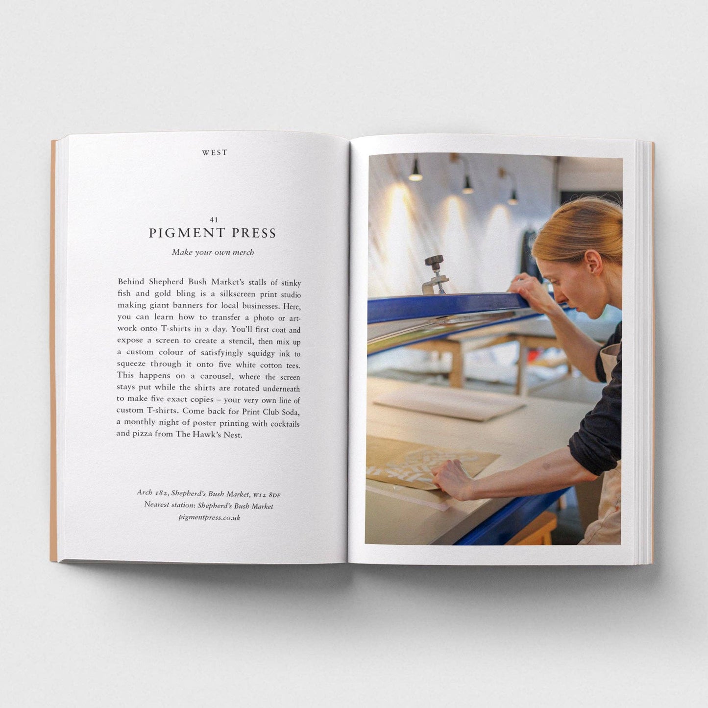 Open book showing a page with text and an image of a person working on a craft project.