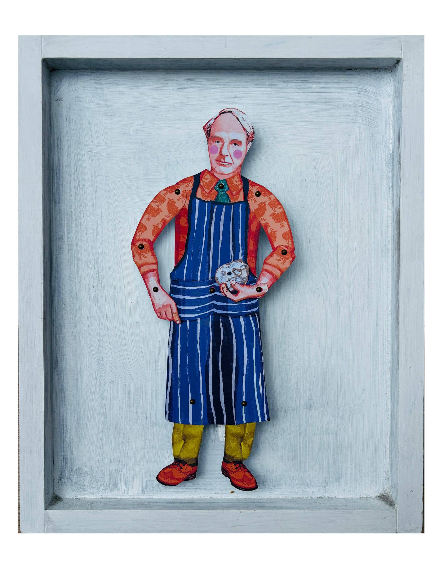 Framed artwork of a person wearing a colorful outfit with a blue apron.