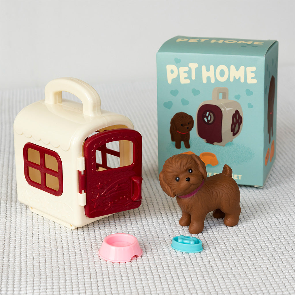 Toy pet house with a toy dog and accessories on a textured surface