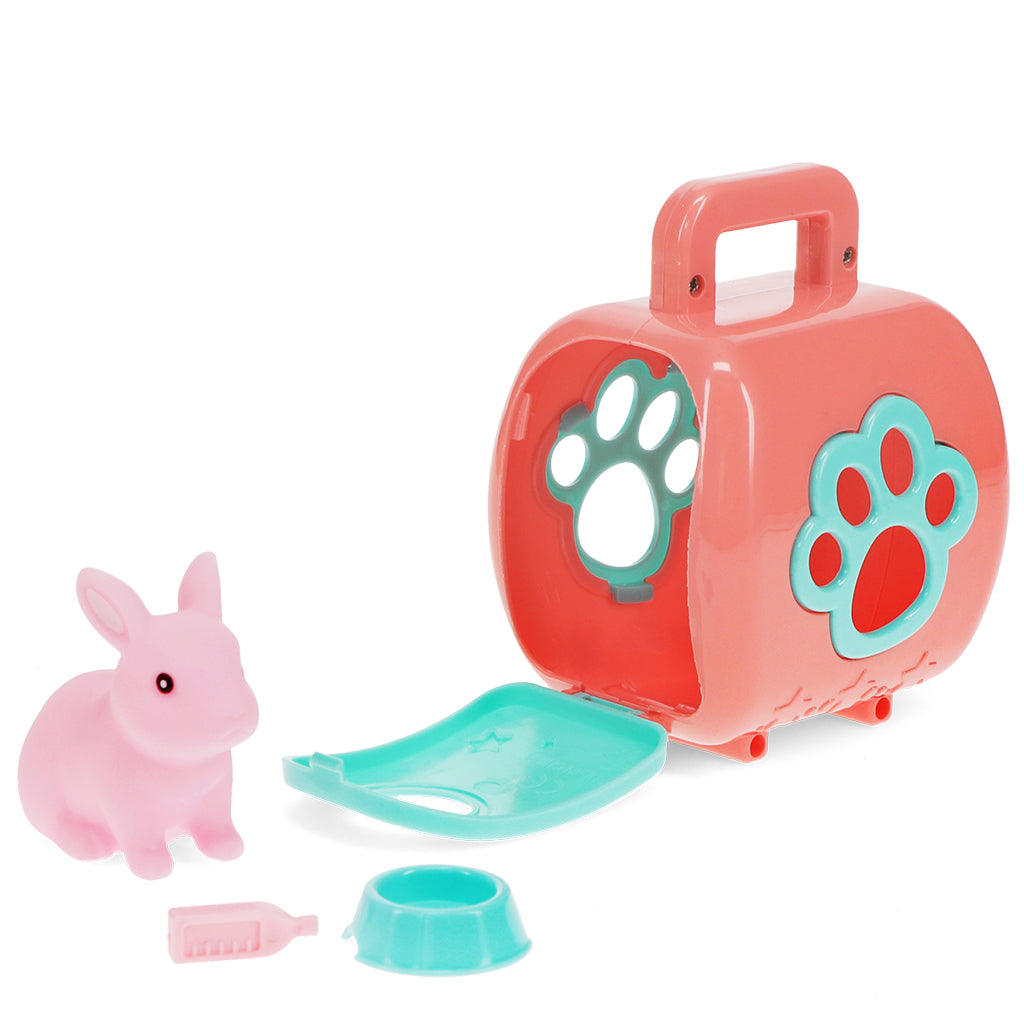 Toy pet carrier with pink rabbit, green tray, and bowl on a white background