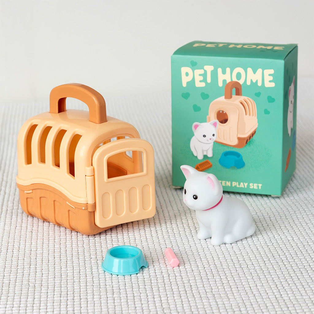 Pet home toy set with carrier, pet figure, and accessories on a textured surface.