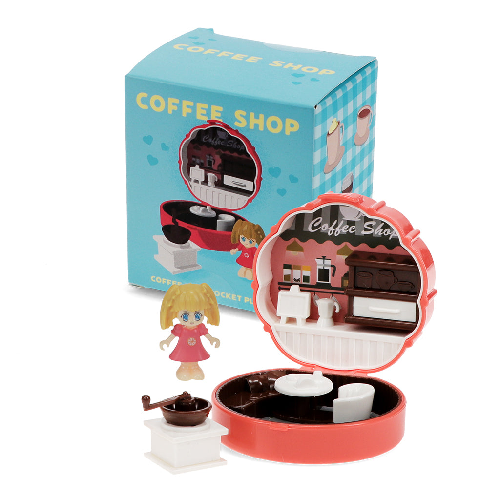 Toy coffee shop set with a small figure and miniature furniture, featuring a 'Coffee Shop' box.