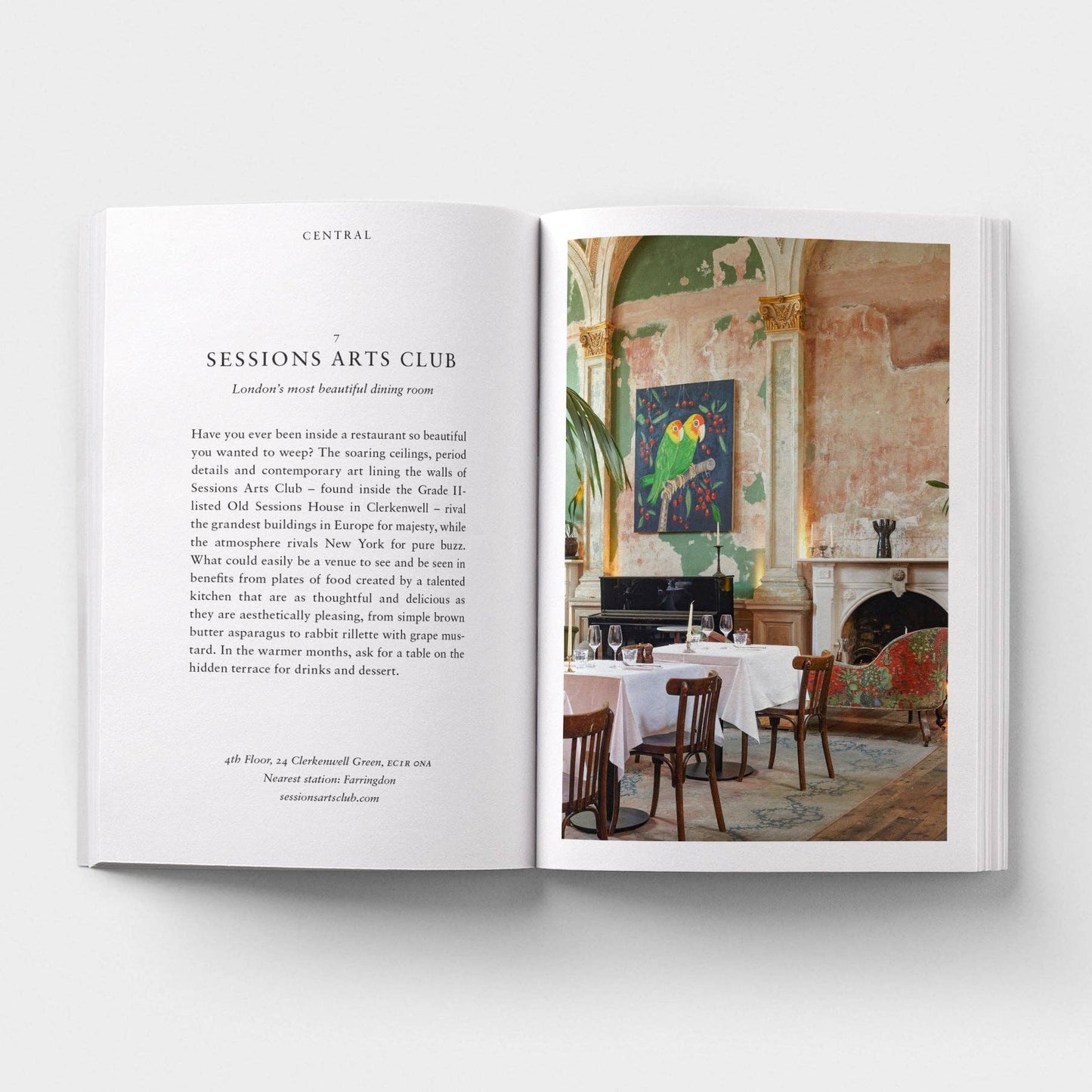 Open book showing a page with text and an image of a dining room.