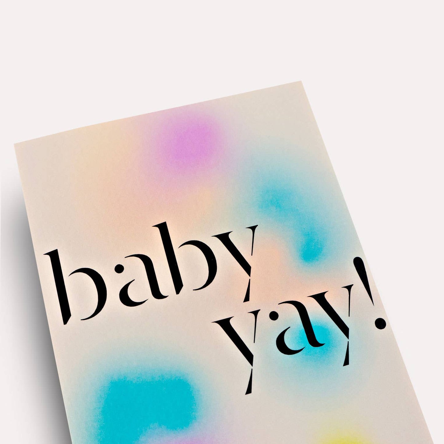 Notebook with 'baby yay!' text on a pastel watercolor background