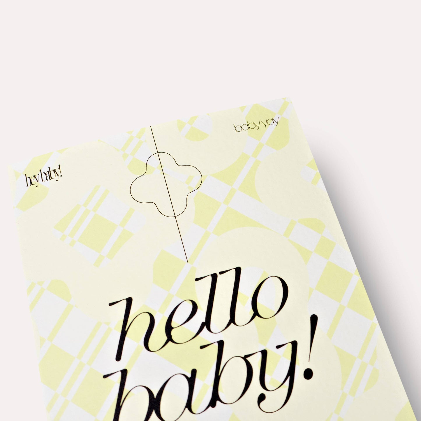 Yellow baby shower invitation with 'hello baby!' text on a white background
