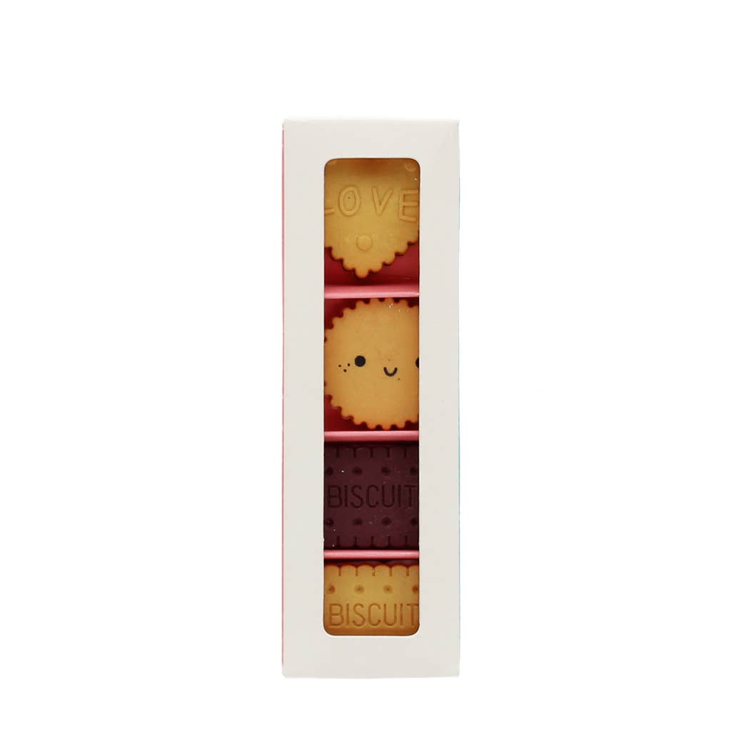 Set of erasers with cute designs in a white box on a white background