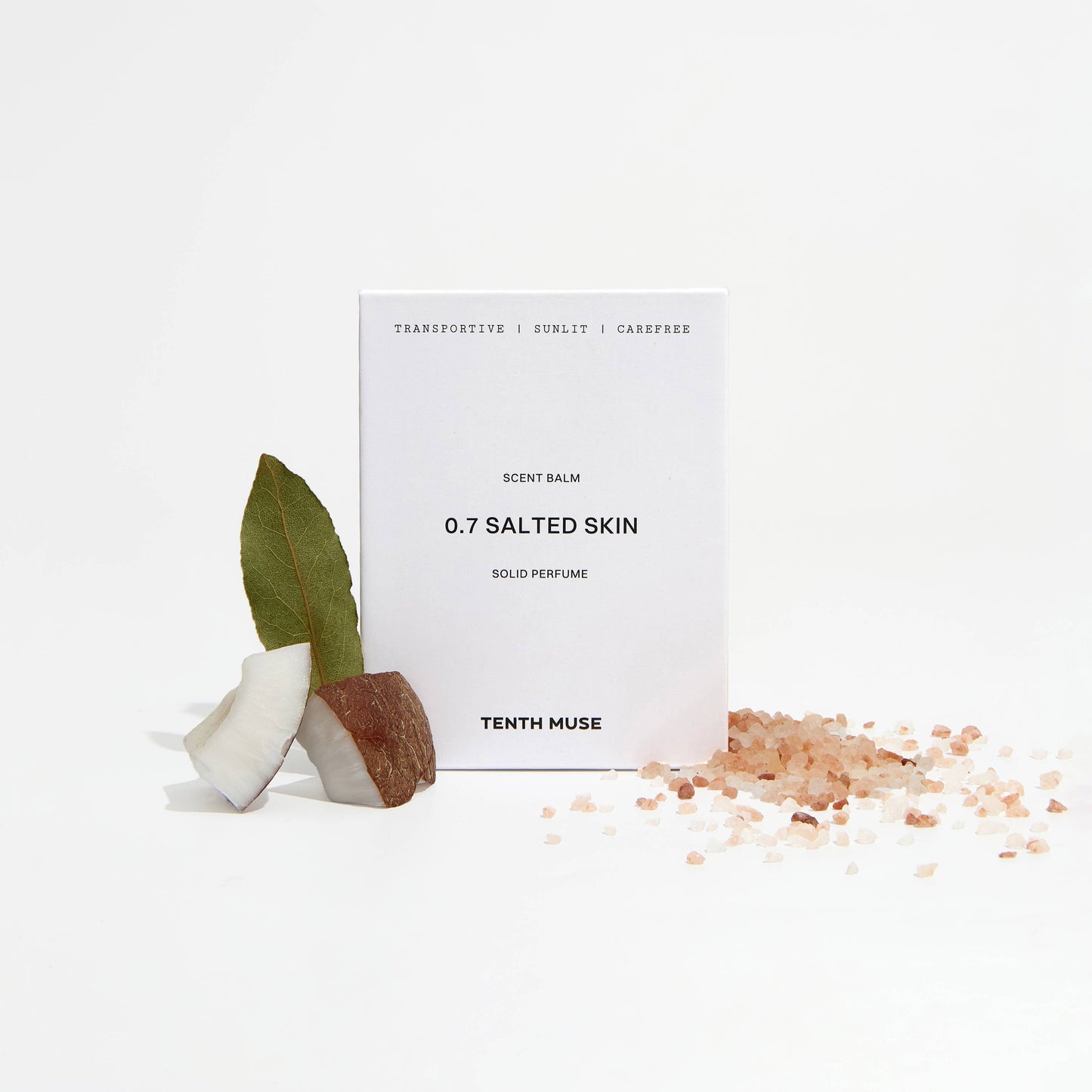 Perfume bottle labeled '0.7 Salted Skin' by Tenth Muse with a small plant and salt crystals on a white background.