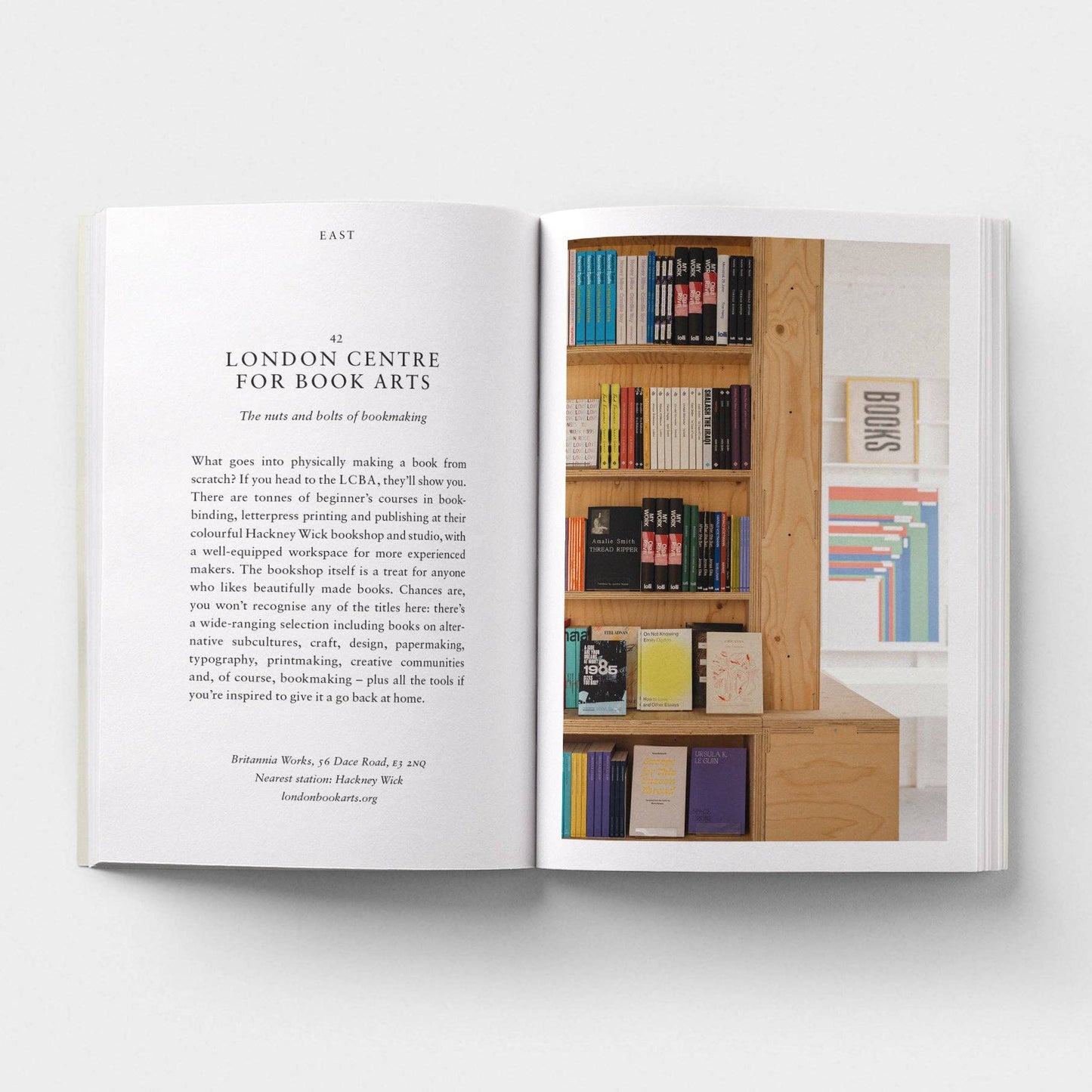 Open book showing text and a photograph of a bookshelf with books.