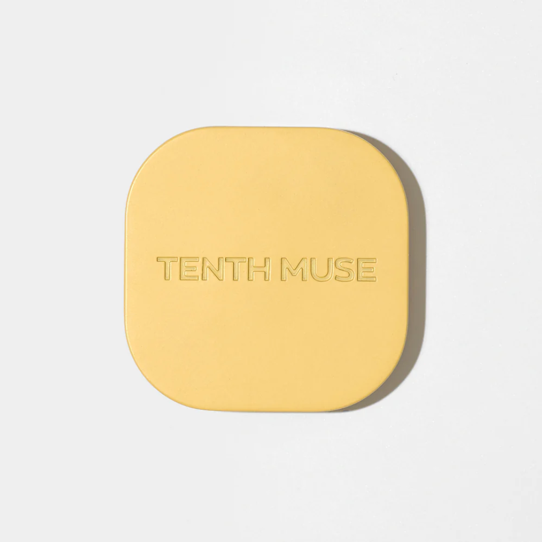 Yellow square compact with 'Tenth Muse' branding on a light gray background