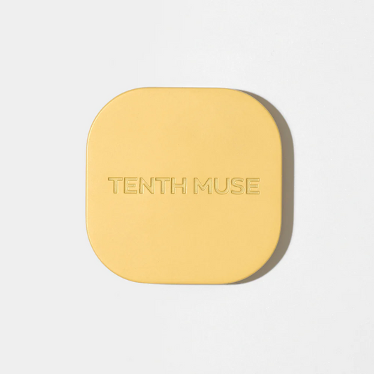 Yellow square compact with 'Tenth Muse' branding on a light gray background