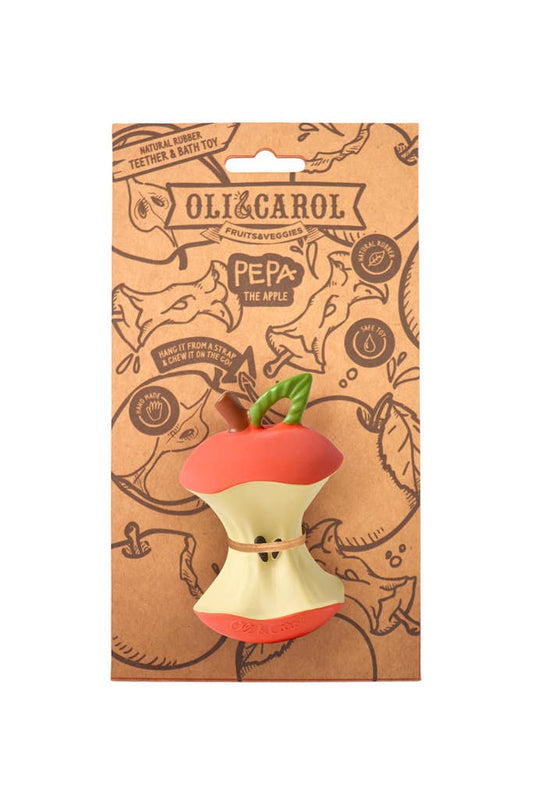 Oli & Carol dog toy packaging with a red and white apple-shaped toy on a brown background.