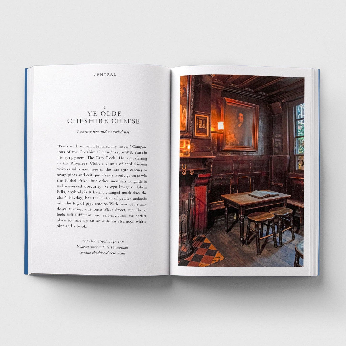 Open book with text and a photograph of a pub interior on a white background