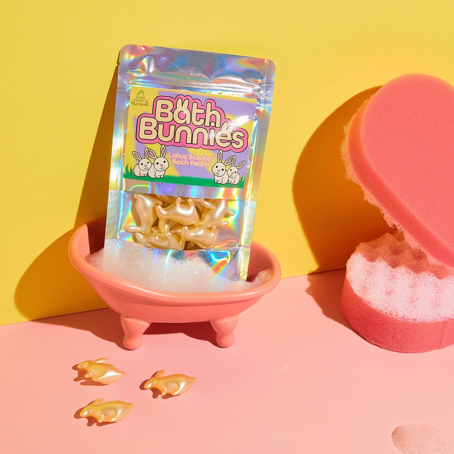 Packaged product labeled 'Bath Bunnies' on a pink stand with a yellow background