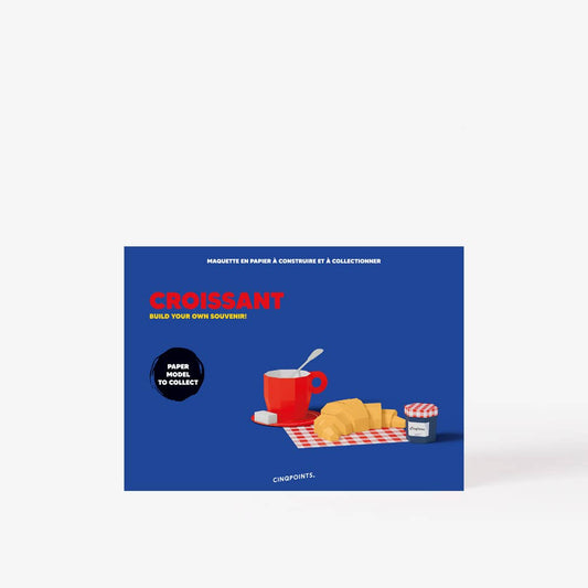 Product packaging with croissants, coffee, and a plate on a blue background