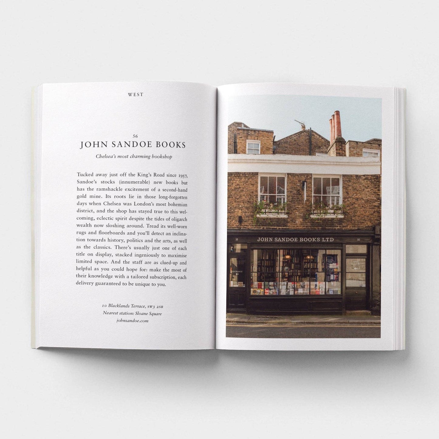 Open book showing text and a photograph of a building