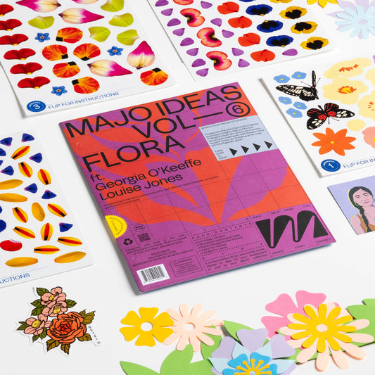 Colorful art supplies including a book titled 'MAJO IDEAS VOL. 6 FLORA' with flower designs on a white background.
