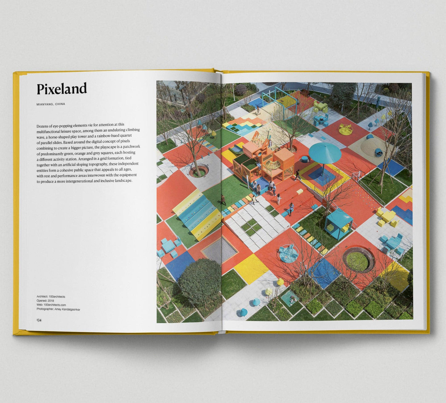 Open book showing a colorful playground design with text on a white background