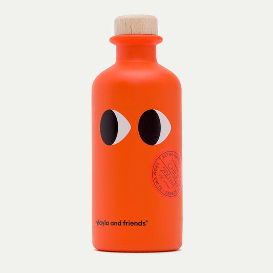 Orange bottle with black eyes and a wooden cap on a white background