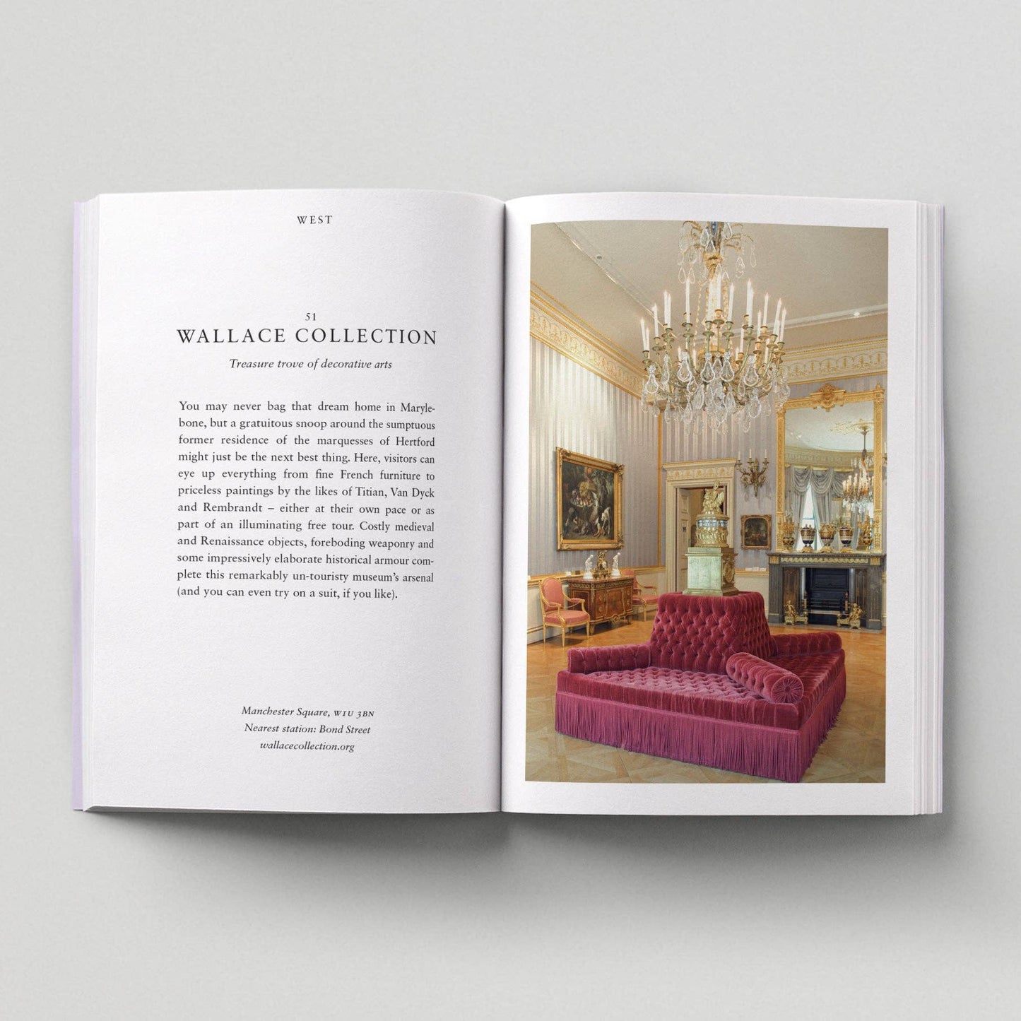 Open book showing a luxurious interior with a chandelier and sofa.