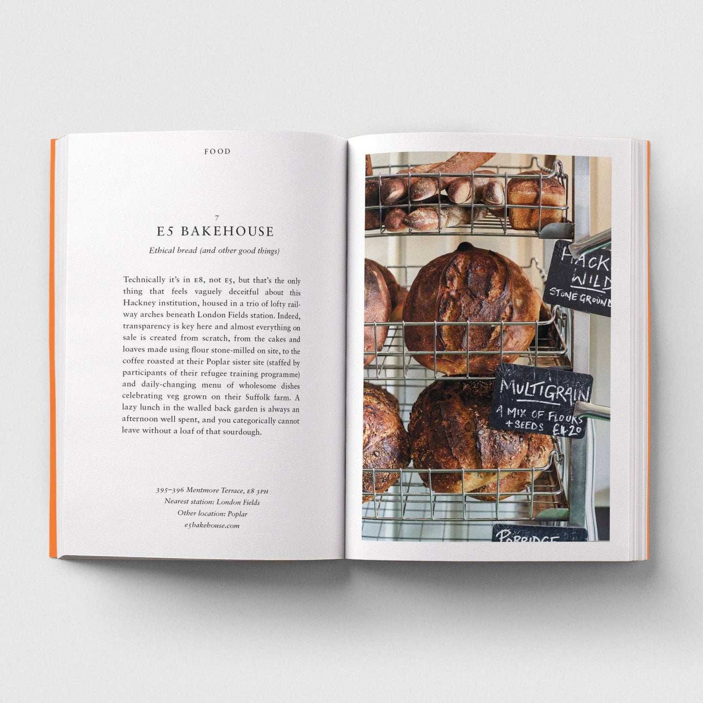 Open book showing a page with text and an image of bread loaves on a rack.