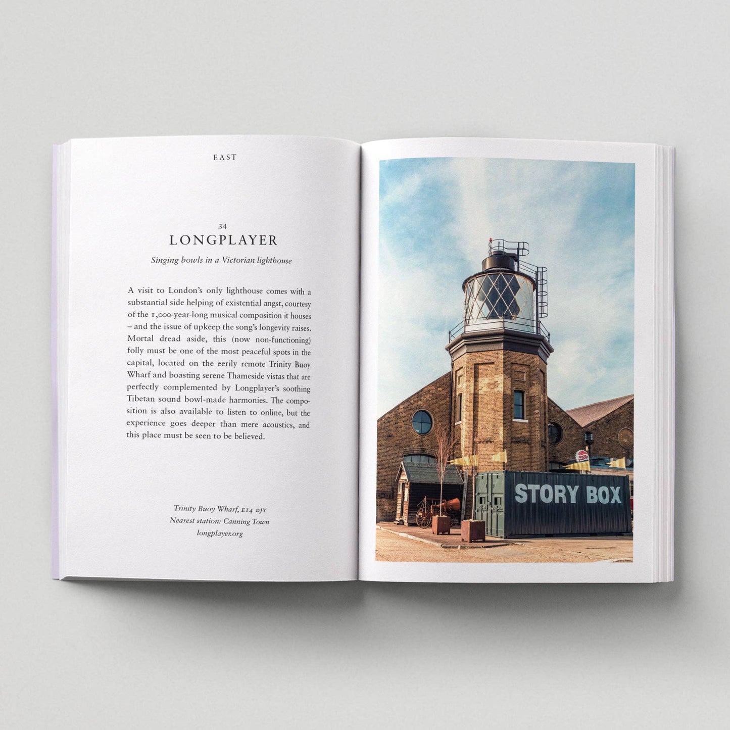 Open book showing a page with text and an image of a lighthouse.