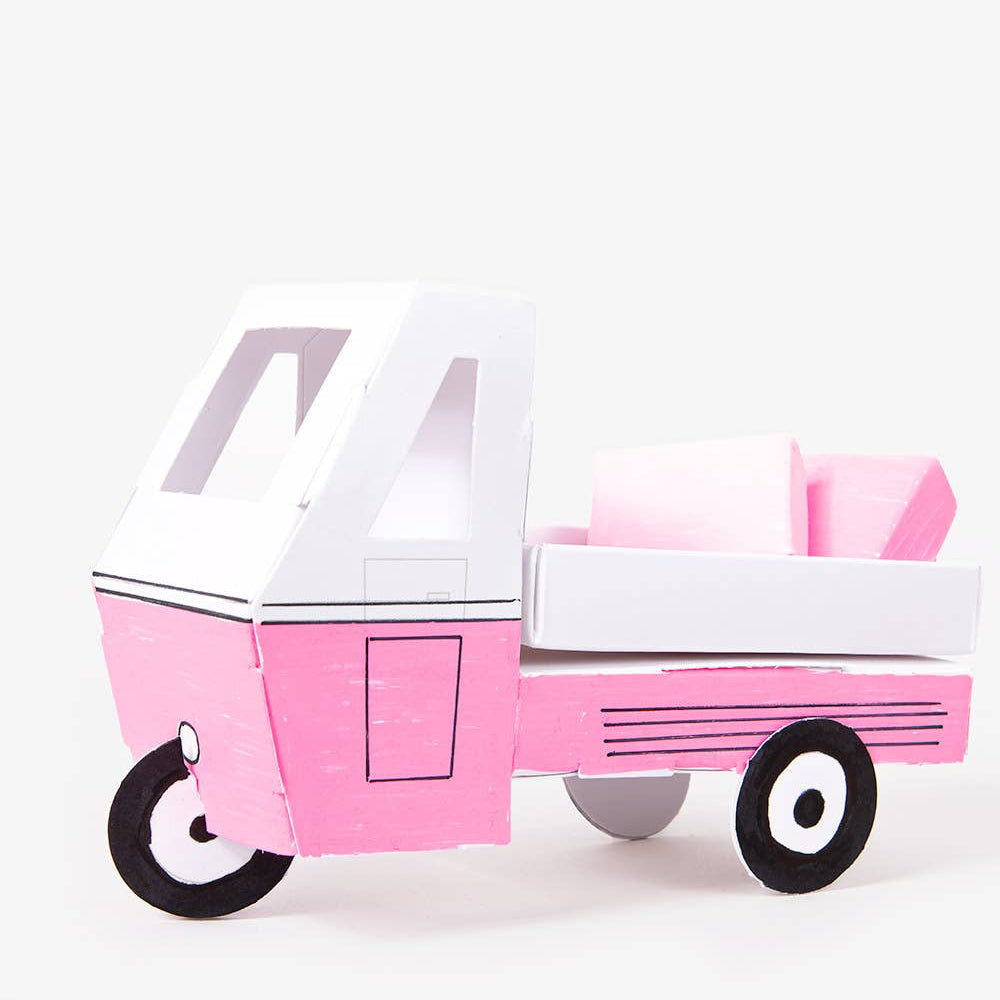 Pink toy camper with a white top on a white background
