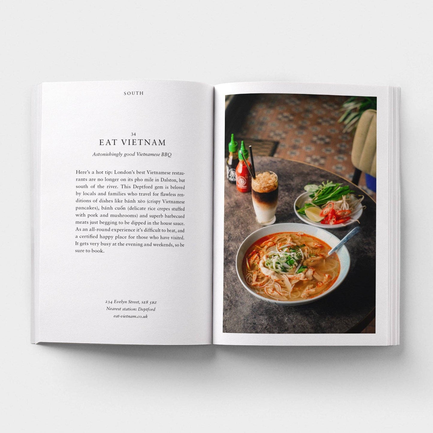 Open book showing a page with text and an image of a bowl of soup on a table.