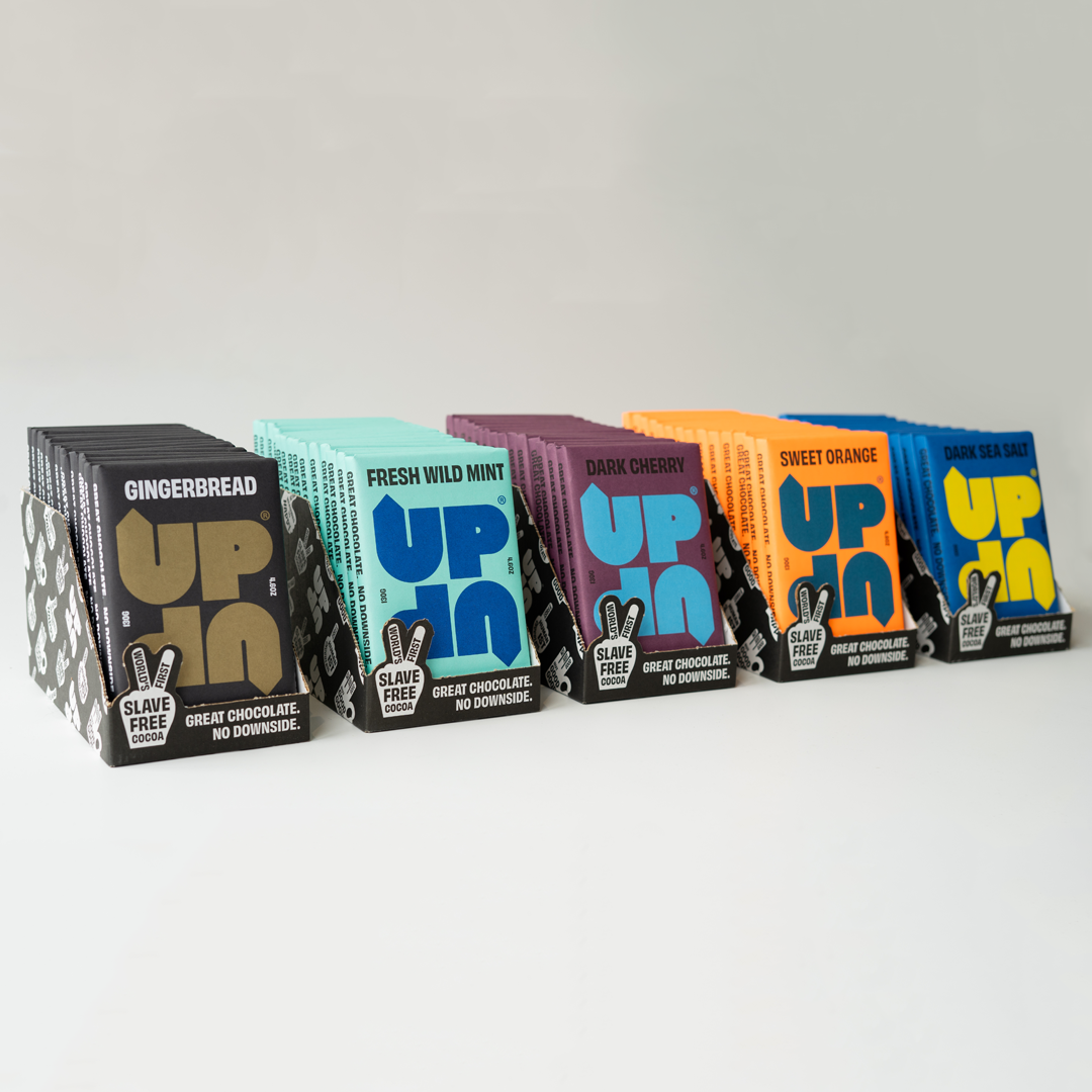 Assorted boxes of 'UP UP' chocolate bars on a light gray background