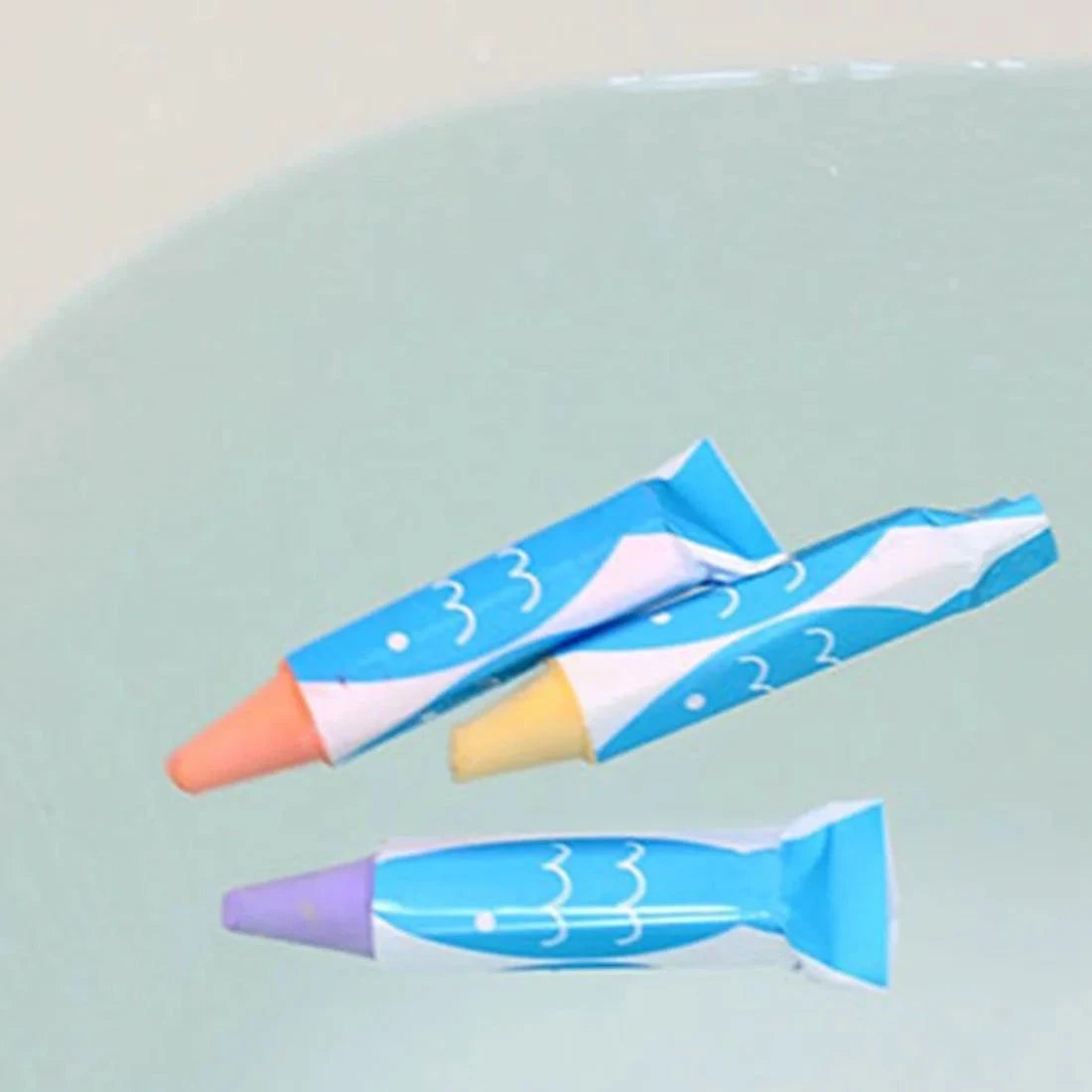 Two colorful crayon-like markers on a light blue surface