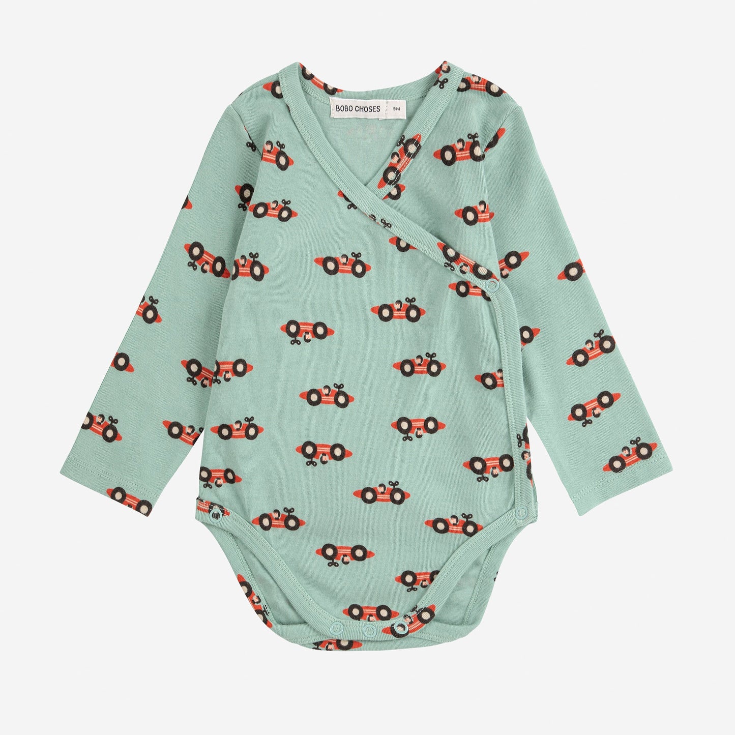 Light green baby onesie with red car pattern on a white background