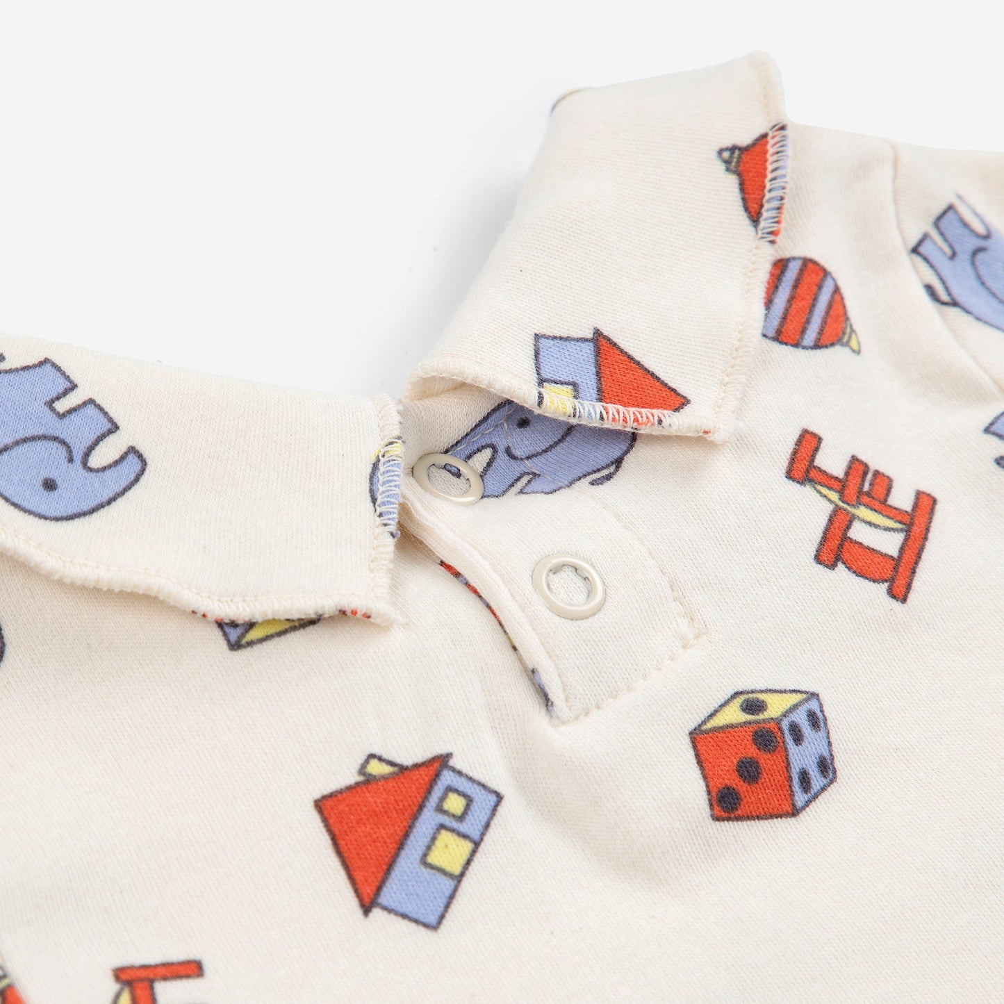 Baby t-shirt with colourful geometric pattern on a white background