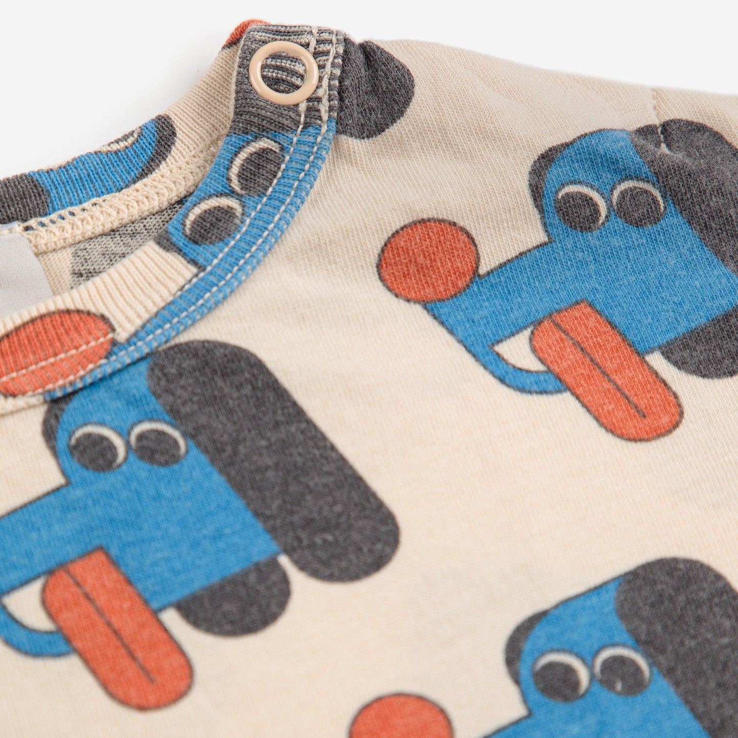 Children's clothing with dog pattern on a plain background